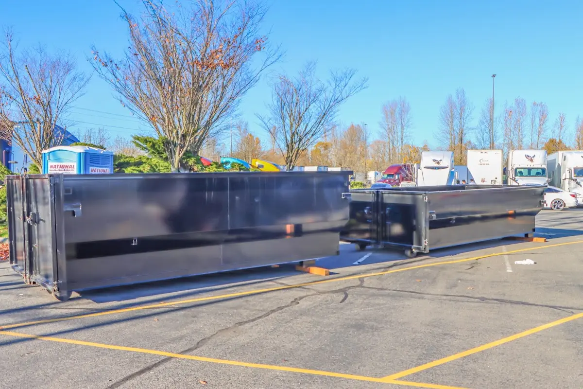 Professional dumpster rental service with roll-off container on residential driveway in Van Wert